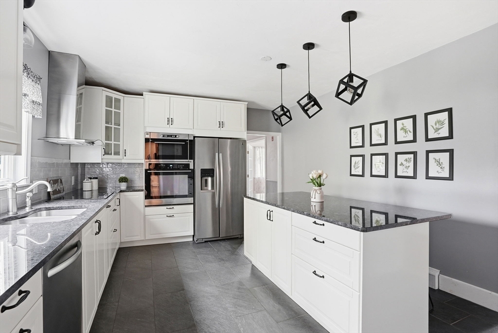 200 Branch Street Mansfield, MA 02048 - Photo 6 of 41 a kitchen with white cabinets and stainless steel appliances