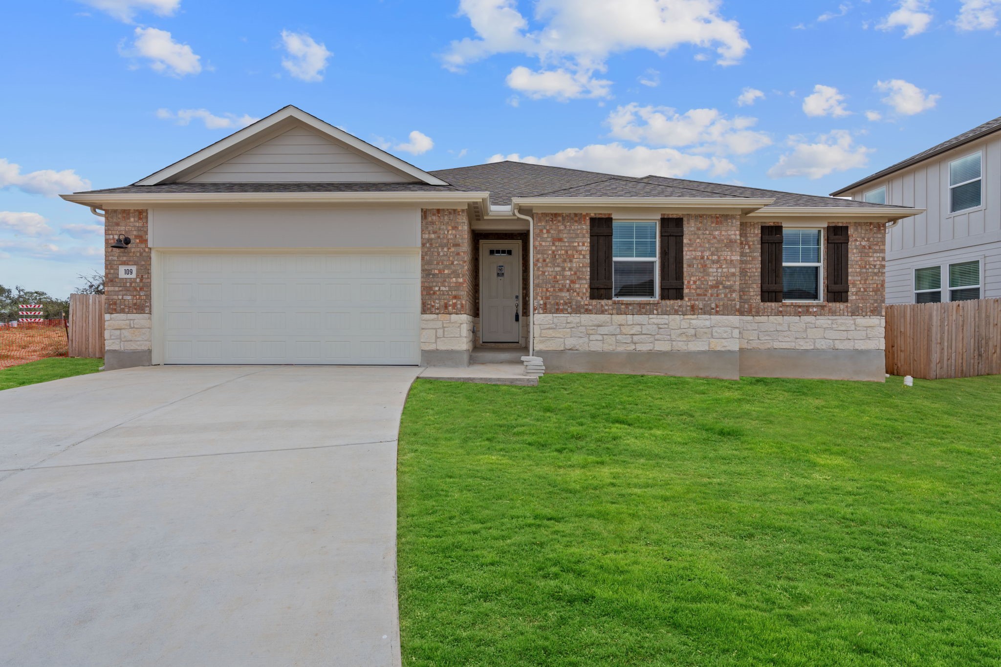 Restricted Address Kyle, TX 78640 - Photo 1 of 39 a front view of a house with a yard and garage