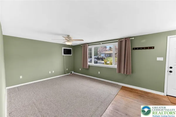 an empty room with painting and windows