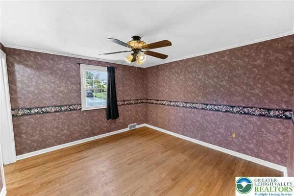 a view of a room with wooden floor