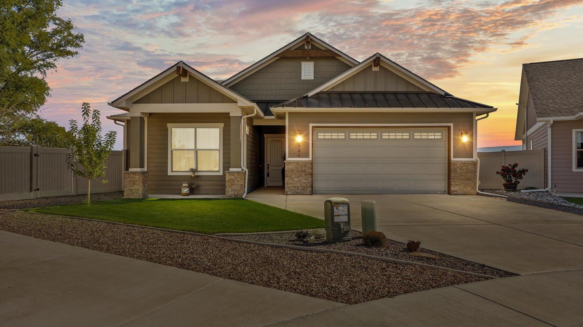 786 Spur Cross Road Grand Junction, CO 81505 - Photo 1 of 27 a front view of a house with a yard and garage