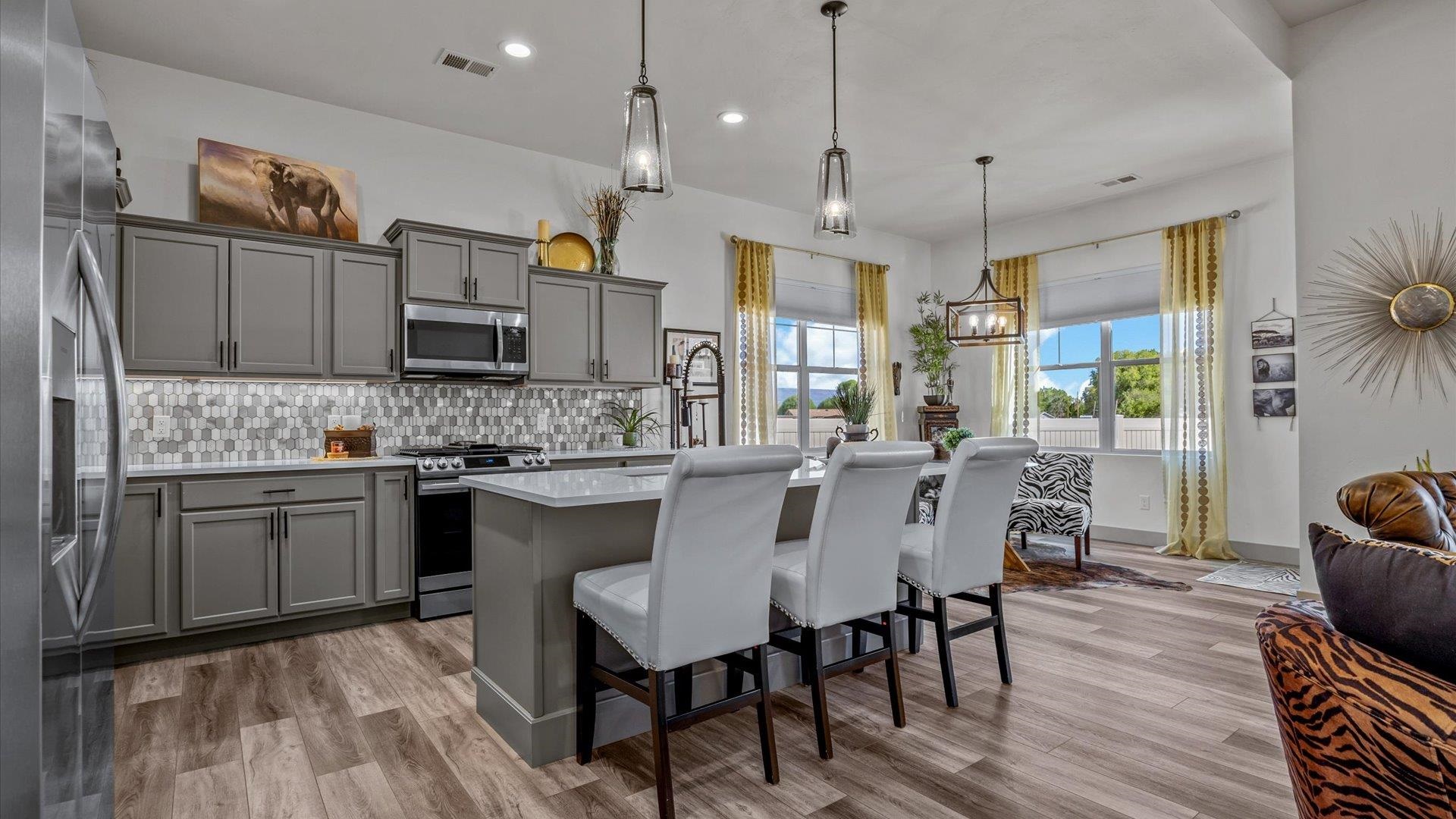 786 Spur Cross Road Grand Junction, CO 81505 - Photo 6 of 27 a kitchen with kitchen island granite countertop a sink counter and chairs