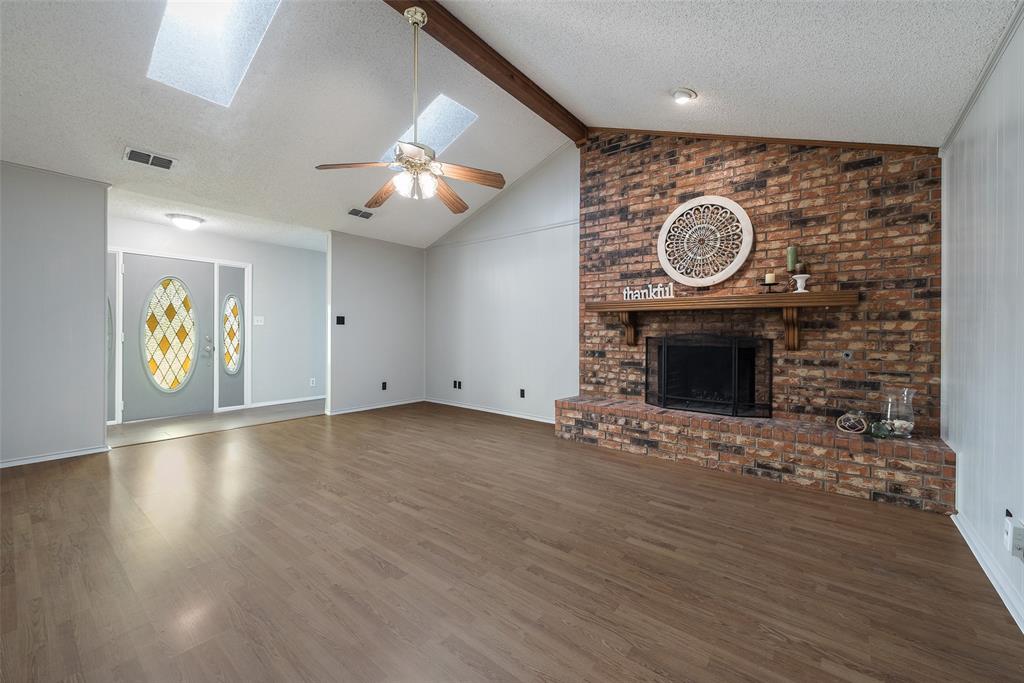 205 Randy Lee Lane McKinney, TX 75071 - Photo 1 of 1 an empty room with wooden floor and a fireplace