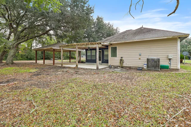 a view of a yard with a house and large trees