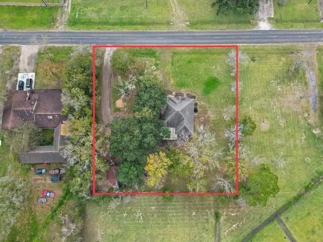 a small yard with table and chairs and potted plants