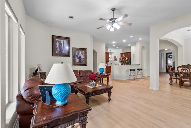 a living room with furniture and kitchen view