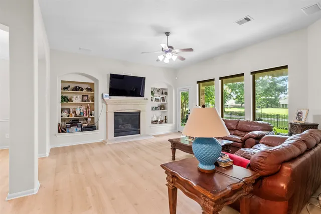 a living room with furniture a fireplace and a flat screen tv