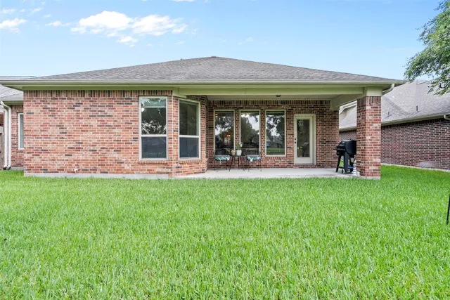 a view of a house with a backyard porch and sitting area