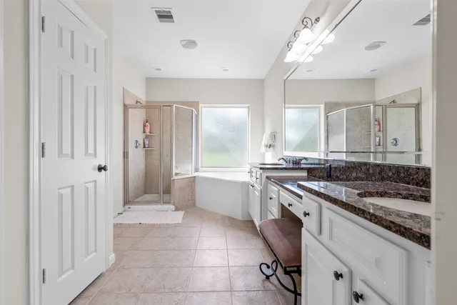 a large white kitchen with a stove a sink dishwasher and a refrigerator