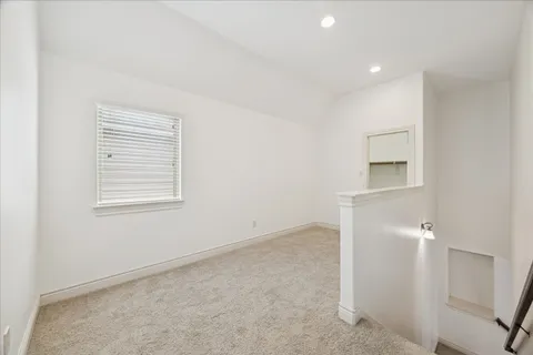 an empty room with windows and closet