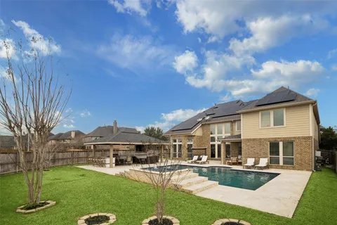 a front view of a house with swimming pool having outdoor seating