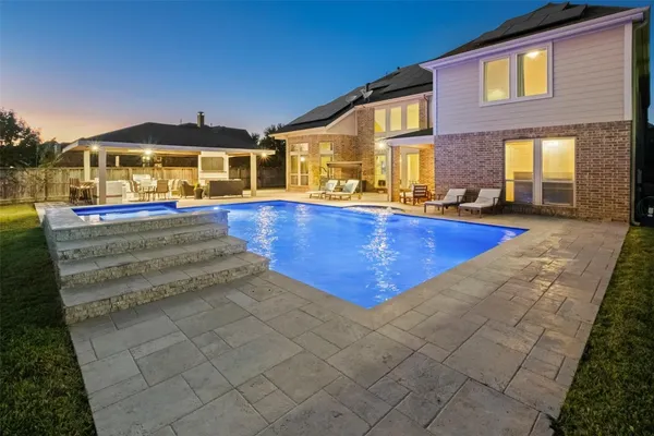 a view of an empty room with a fireplace and wooden floor
