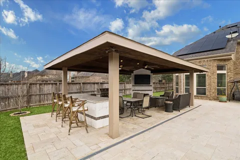 a view of a patio with table and chairs next to a yard