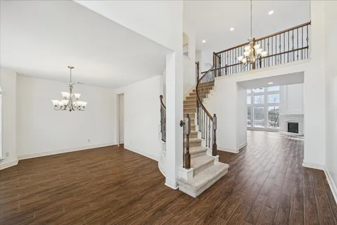 a view of entryway and hall with wooden floor