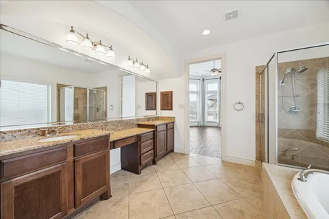 a large bathroom with a granite countertop sink mirror and shower