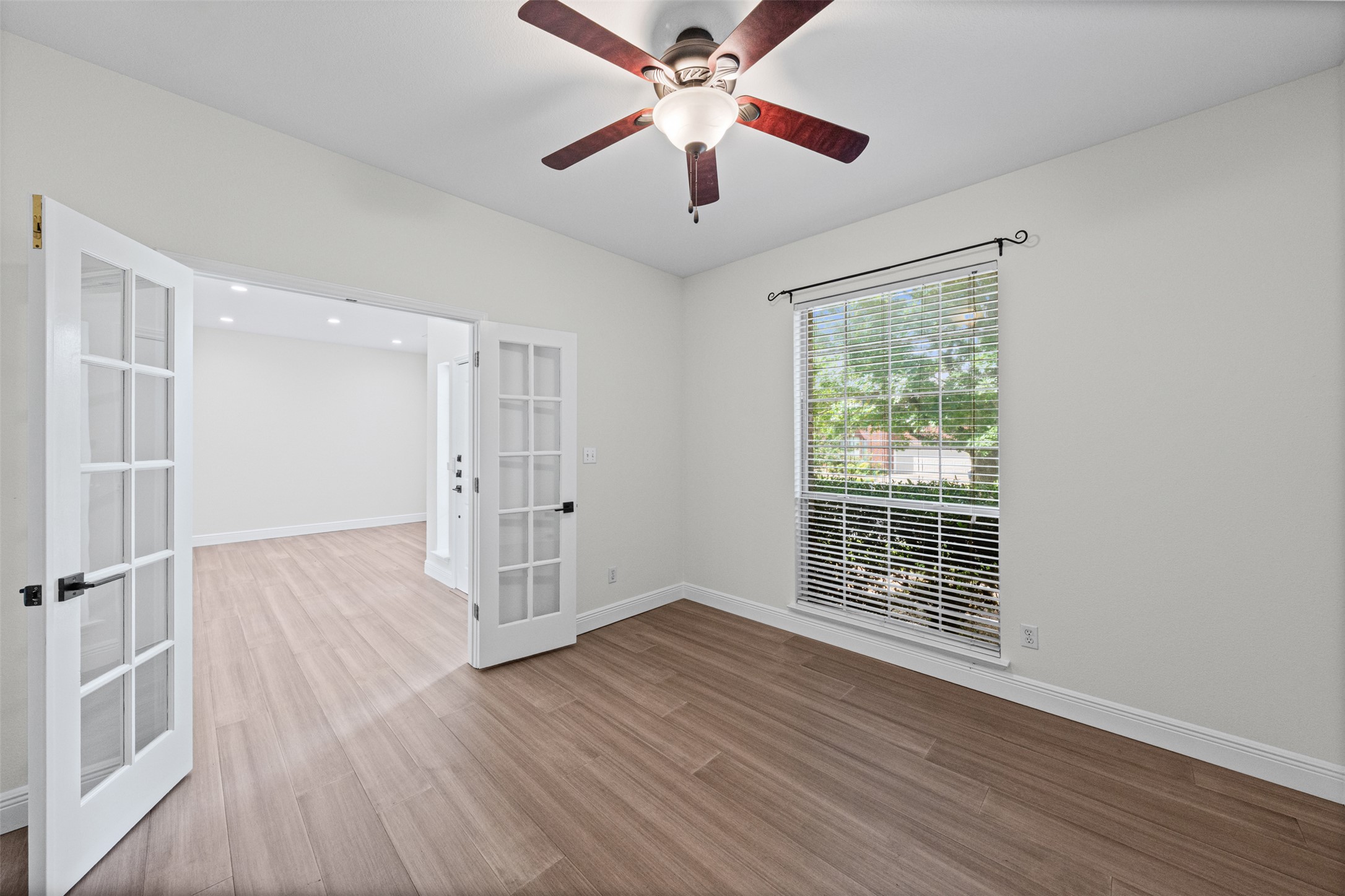 8820 Colberg Drive Austin, TX 78749 - Photo 12 of 35 French doors introduce a versatile office space, well-lit by natural illumination from the window.