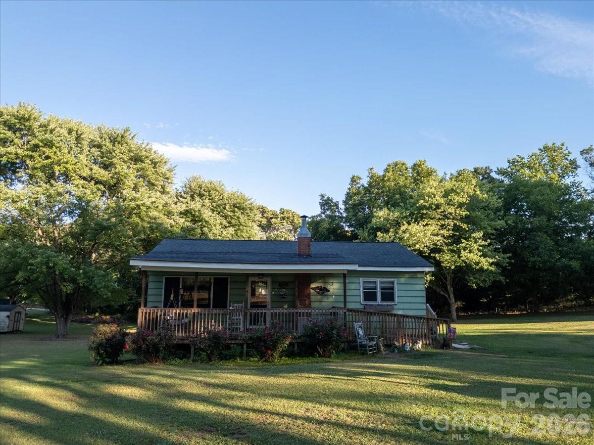 12282 Coyle Road Stanfield, NC 28163 - Photo 23 of 24 a view of a big house with a big yard and potted plants and large trees