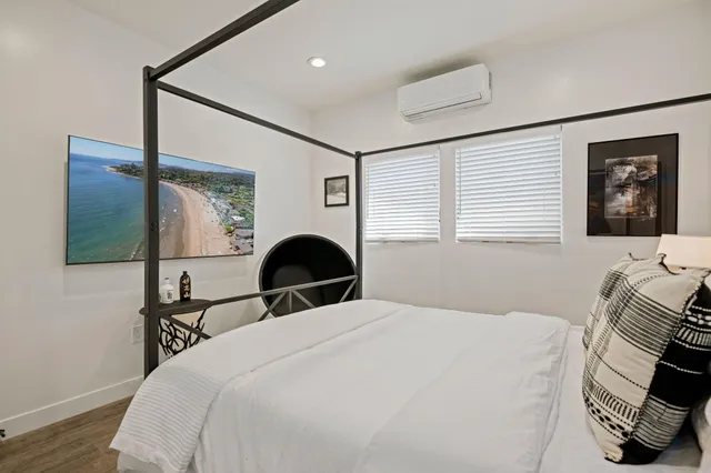 a bedroom with a bed and a painting on the wall