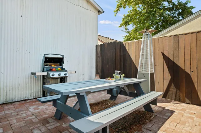 a view of a dinning table and chairs in the patio