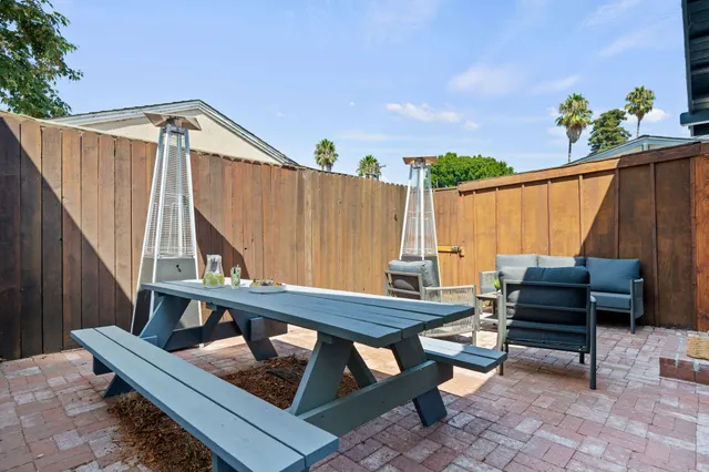 a view of a patio with a table and chairs
