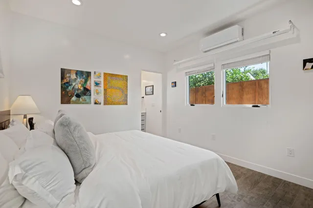 a bedroom with a bed and a painting