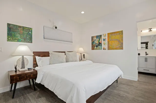 a bedroom with a bed and a lamp