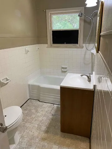 a bathroom with a sink a toilet and bathtub