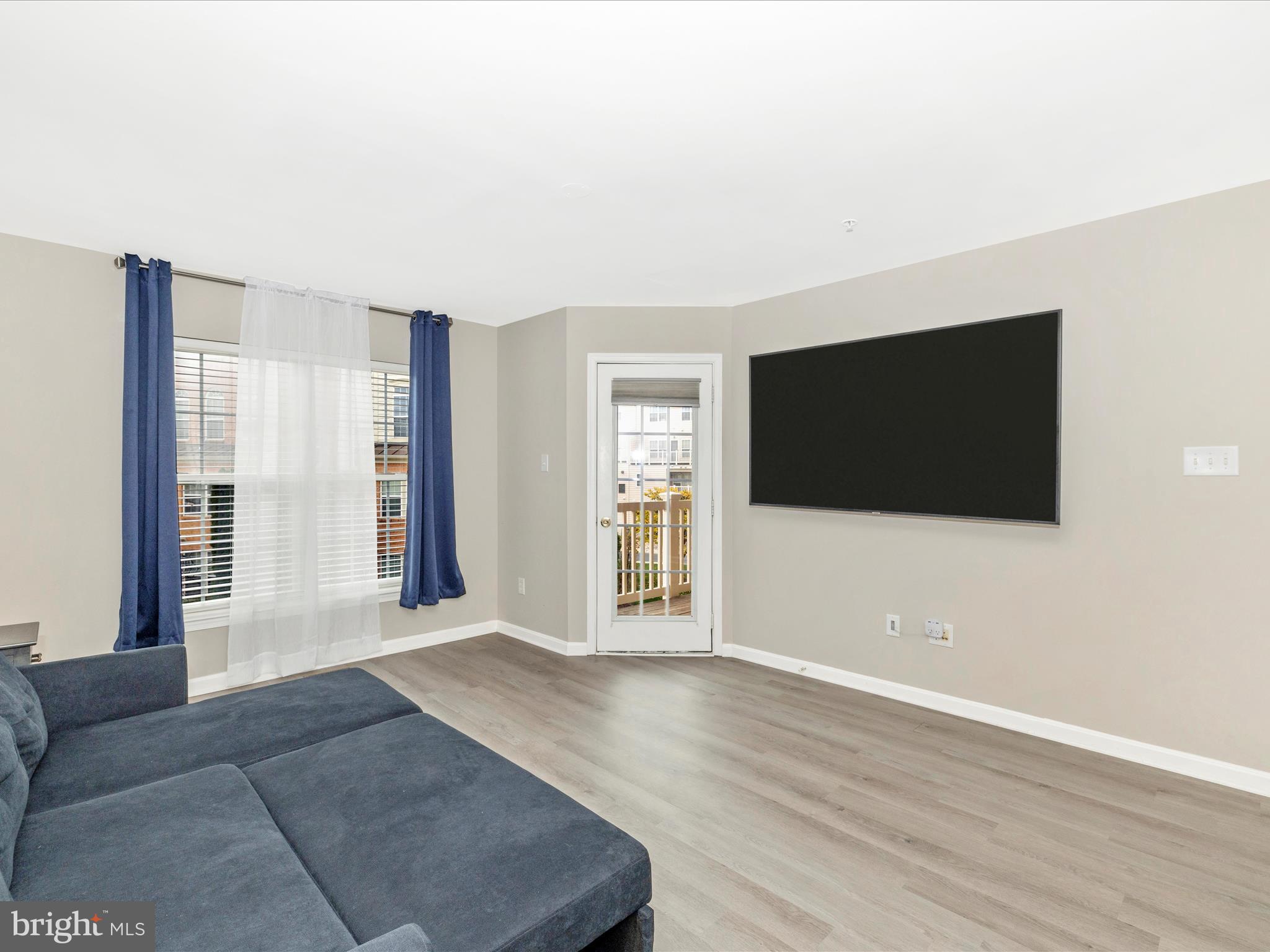 1813 Wheyfield Drive, Unit 10A Frederick, MD 21701 - Photo 20 of 50 a view of a livingroom with wooden floor and a flat screen tv