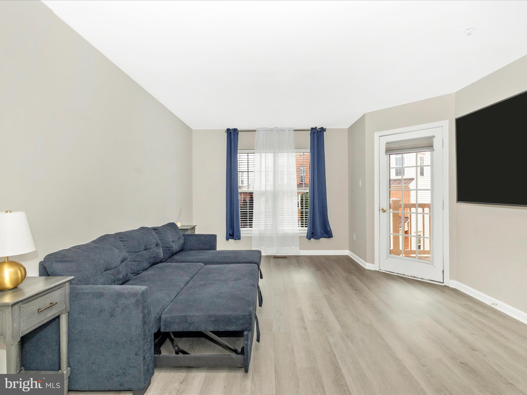 1813 Wheyfield Drive, Unit 10A Frederick, MD 21701 - Photo 21 of 50 a living room with furniture and a flat screen tv