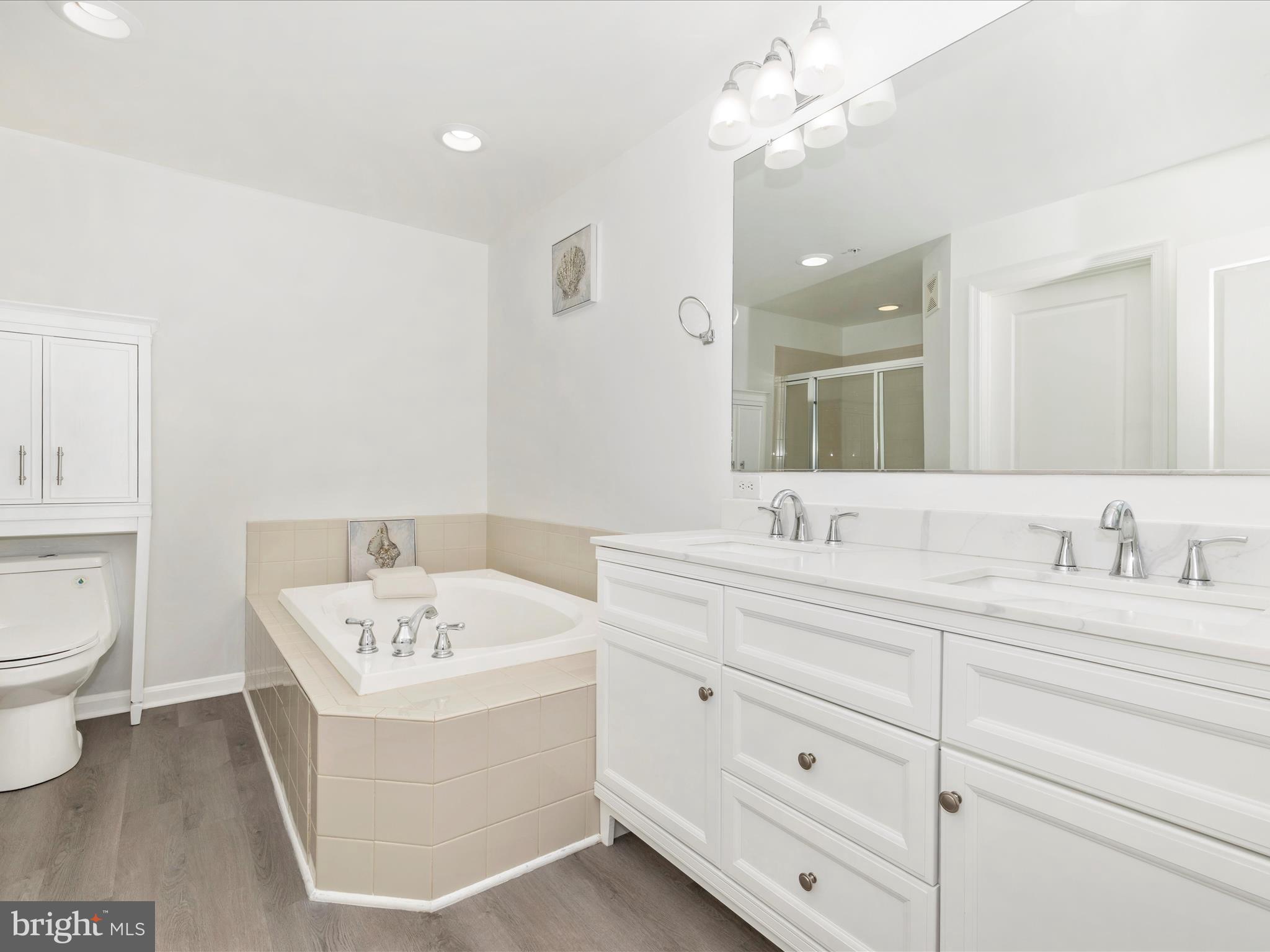 1813 Wheyfield Drive, Unit 10A Frederick, MD 21701 - Photo 24 of 50 a bathroom with a double vanity sink mirror and toilet