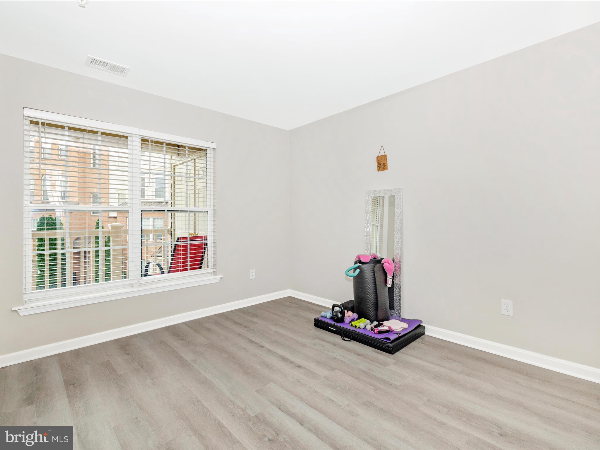 1813 Wheyfield Drive, Unit 10A Frederick, MD 21701 - Photo 28 of 50 an empty room with wooden floor and windows