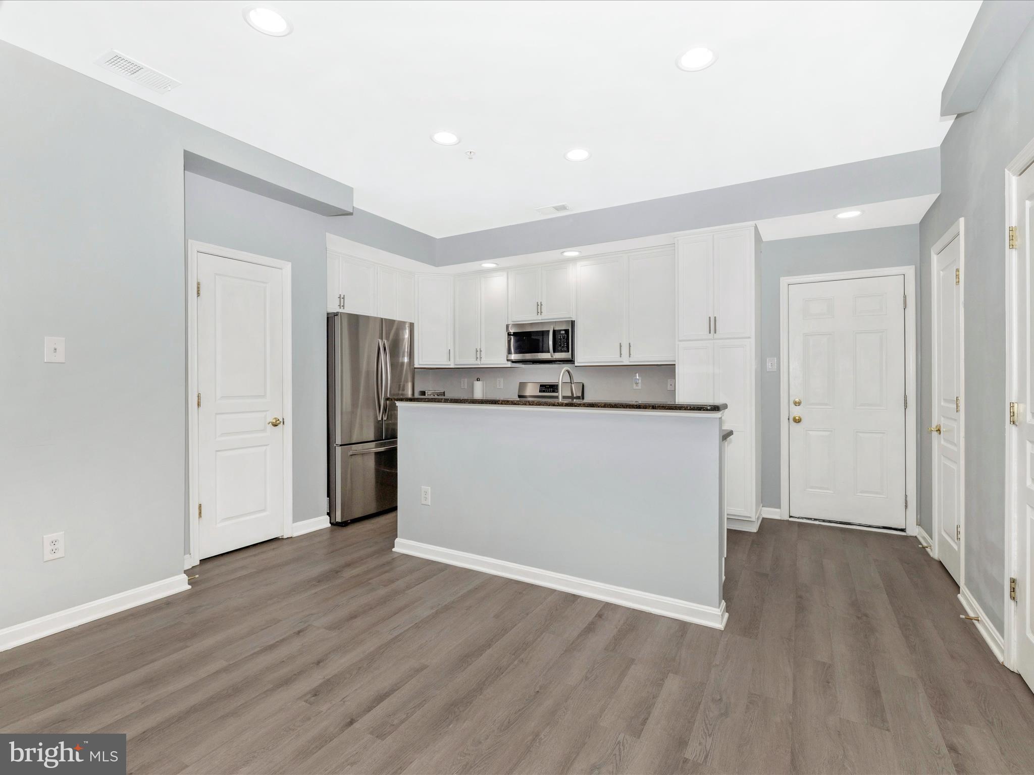 1813 Wheyfield Drive, Unit 10A Frederick, MD 21701 - Photo 10 of 50 a view of a kitchen with a sink cabinets and wooden floor