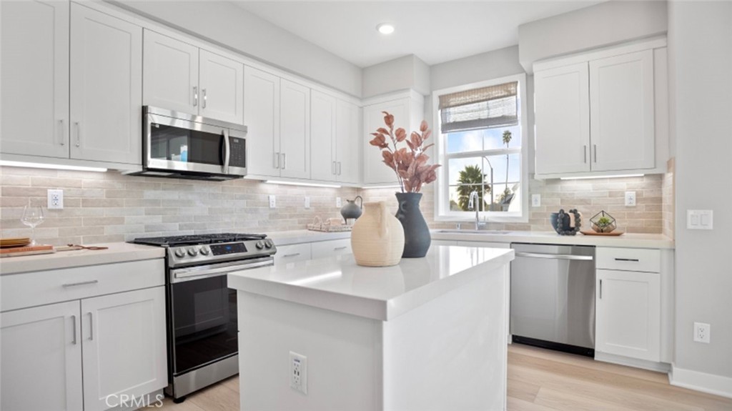 1074 North Anaheim Boulevard, Unit 2 Anaheim, CA 92801 - Photo 1 of 21 a kitchen with white cabinets and appliances