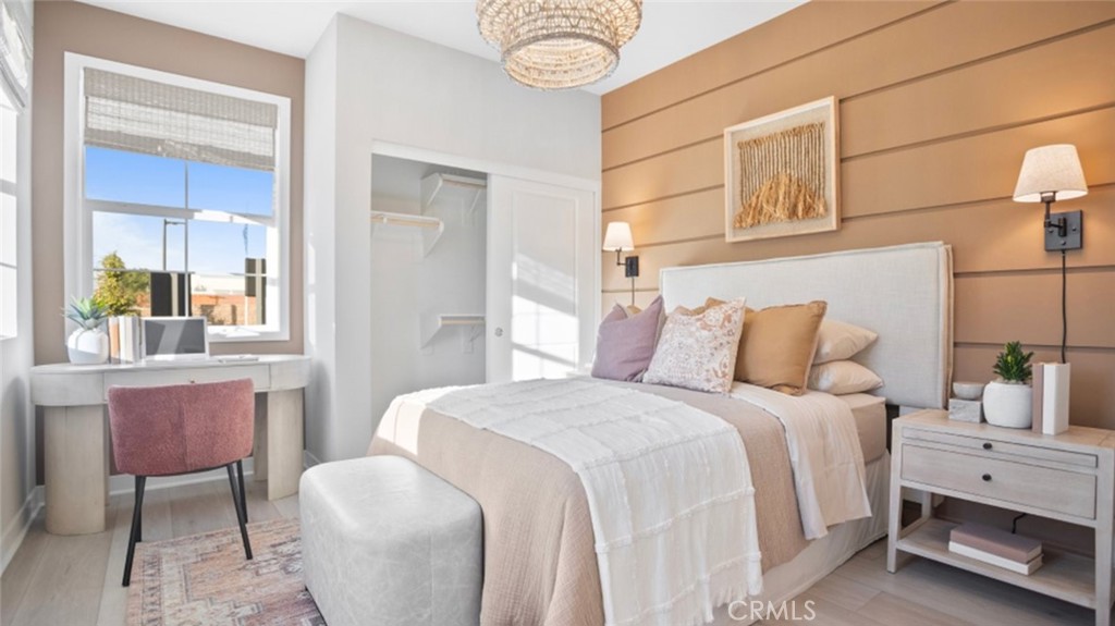 1074 North Anaheim Boulevard, Unit 2 Anaheim, CA 92801 - Photo 15 of 21 a bedroom with a bed a table and chair