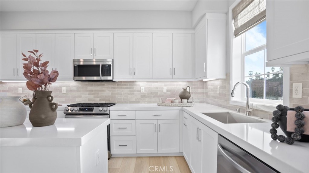 1074 North Anaheim Boulevard, Unit 2 Anaheim, CA 92801 - Photo 2 of 21 a kitchen with stainless steel appliances granite countertop a sink a stove and a microwave