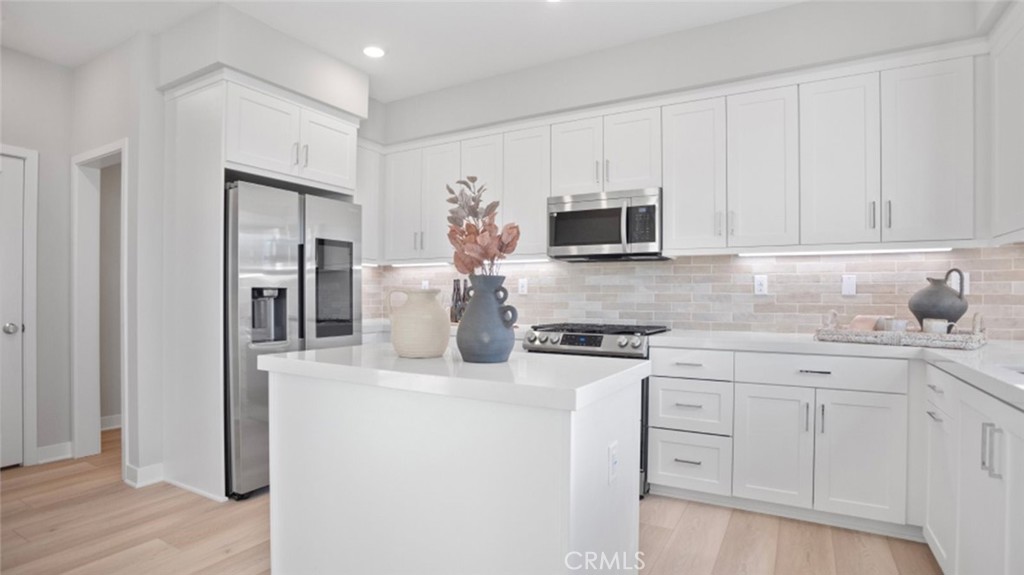 1074 North Anaheim Boulevard, Unit 2 Anaheim, CA 92801 - Photo 3 of 21 a kitchen with appliances a sink and a counter top space