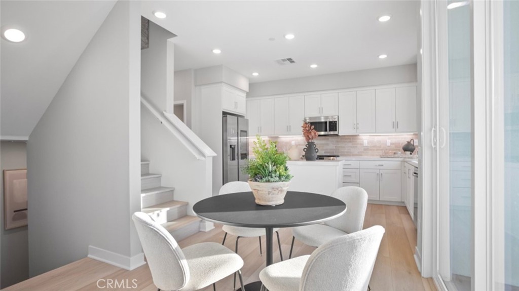 1074 North Anaheim Boulevard, Unit 2 Anaheim, CA 92801 - Photo 5 of 21 a kitchen with a table and chairs in it