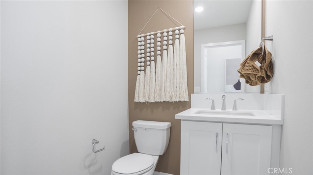 1074 North Anaheim Boulevard, Unit 2 Anaheim, CA 92801 - Photo 10 of 21 a bathroom with a toilet sink and mirror