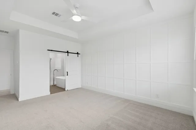 a bedroom with furniture and a large window