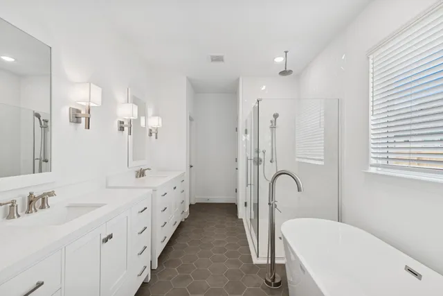 a spacious bathroom with a bathtub and sink