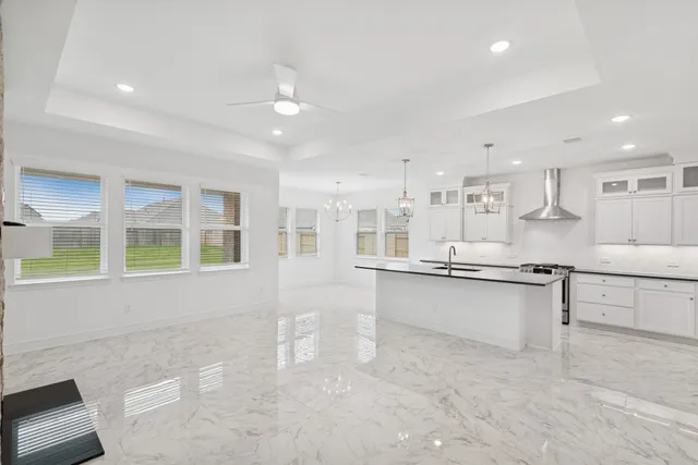 a large kitchen with kitchen island a sink stainless steel appliances and cabinets