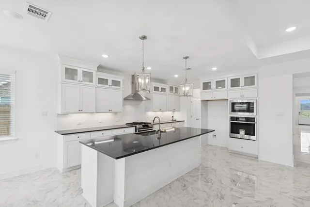 a kitchen that has a sink a stove and a window