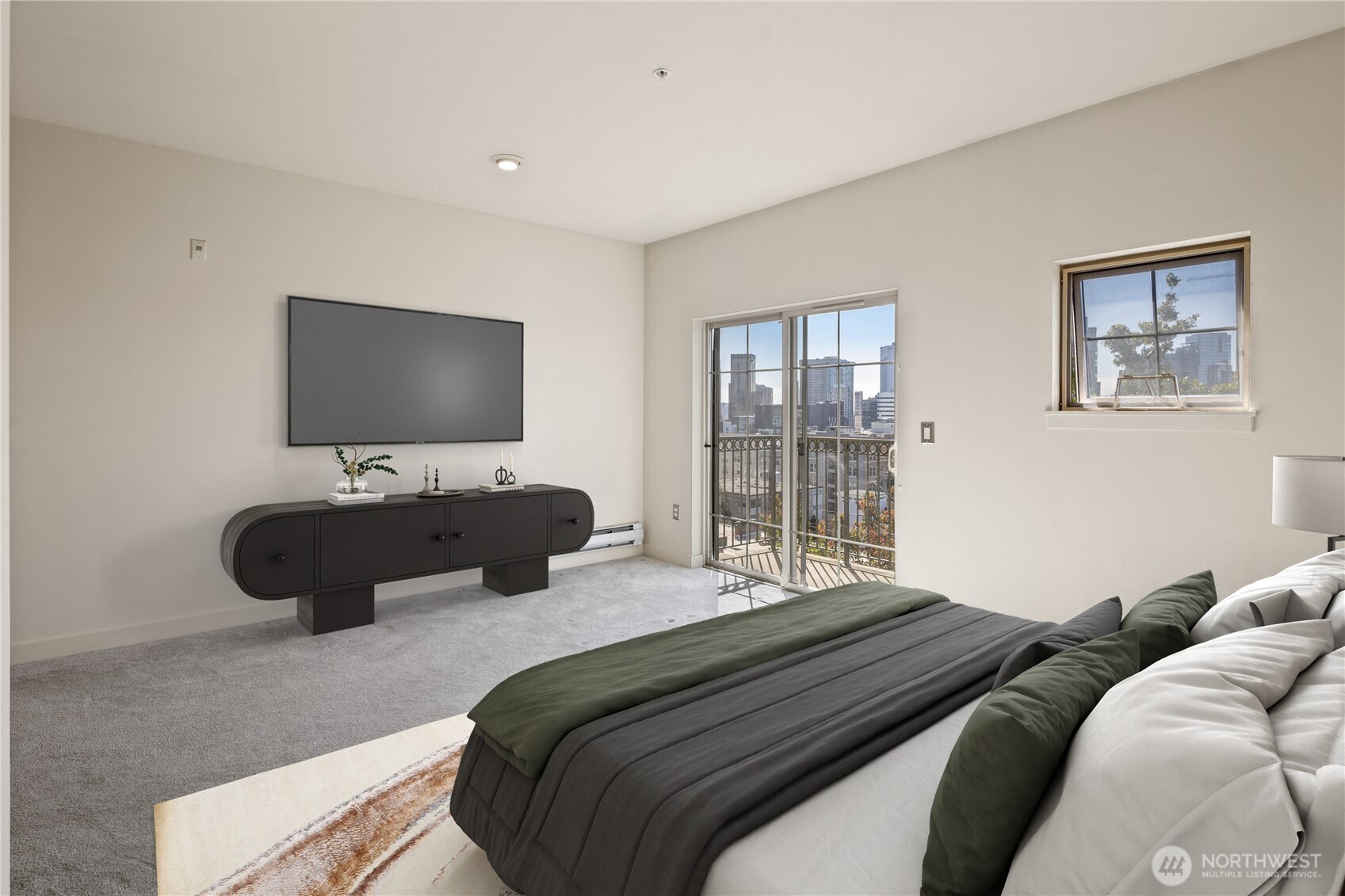 700 East Denny Way, Unit 603 Seattle, WA 98122 - Photo 18 of 37 a bedroom with a bed and a flat screen tv