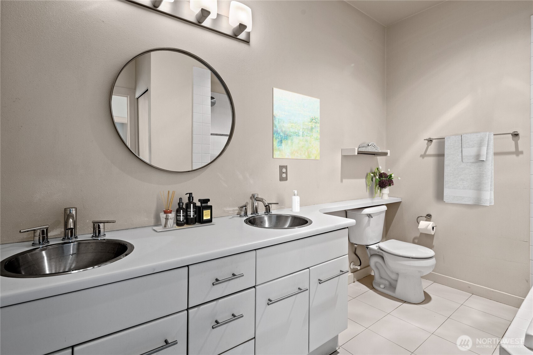 700 East Denny Way, Unit 603 Seattle, WA 98122 - Photo 20 of 37 a bathroom with a toilet sink and mirror