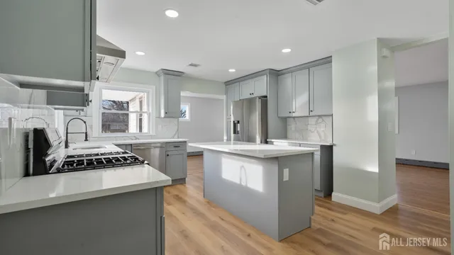 a kitchen with stainless steel appliances a sink stove and refrigerator