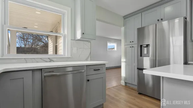 a kitchen with stainless steel appliances granite countertop a refrigerator and a sink