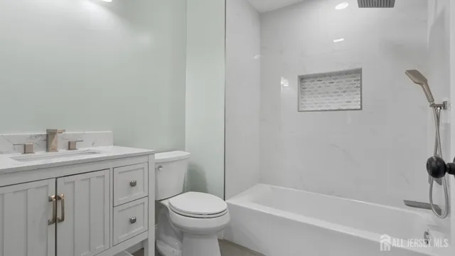a white toilet sitting next to a bath tub