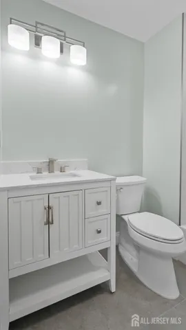 a bathroom with a sink a toilet and vanity
