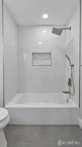 a bathroom with a bathtub and a toilet