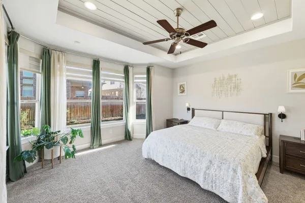 a view of a livingroom with workspace and a ceiling fan